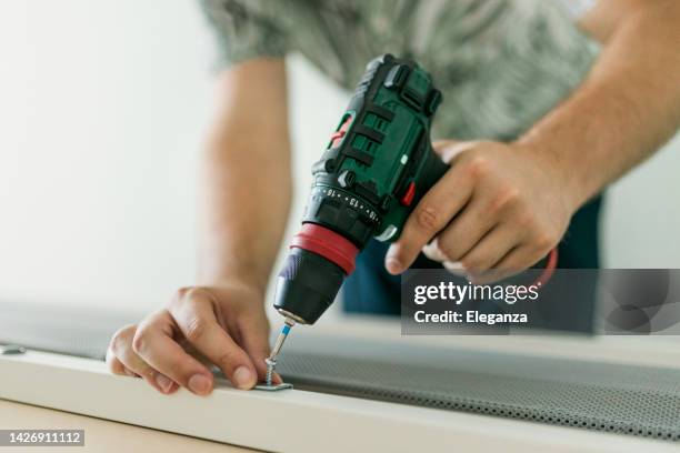 close up of man doing renovation work at home - broca imagens e fotografias de stock
