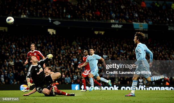 David Silva of Manchester City scores his team's fourth goal during the Barclays Premier League match between Manchester City and West Bromwich...
