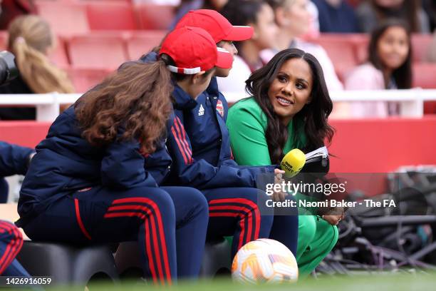 Pundit Alex Scott speaks with ball kids during the FA Women's Super League match between Arsenal and Tottenham Hotspur at Emirates Stadium on...