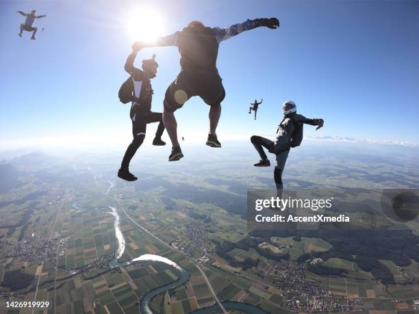 skydivers fall upside down, in aerial flight - skydiving stock pictures, royalty-free photos & images