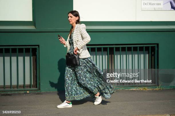 Guest wears a white with black checkered print pattern tweed jacket, a navy blue / green flower print pattern V-neck / long dress, a black shiny...