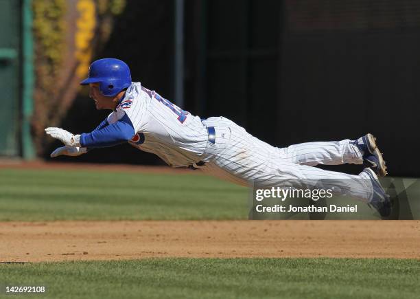 Darwin Barney of the Chicago Cubs dives safely into 2nd base against the Milwaukee Brewers at Wrigley Field on April 11, 2012 in Chicago, Illinois.