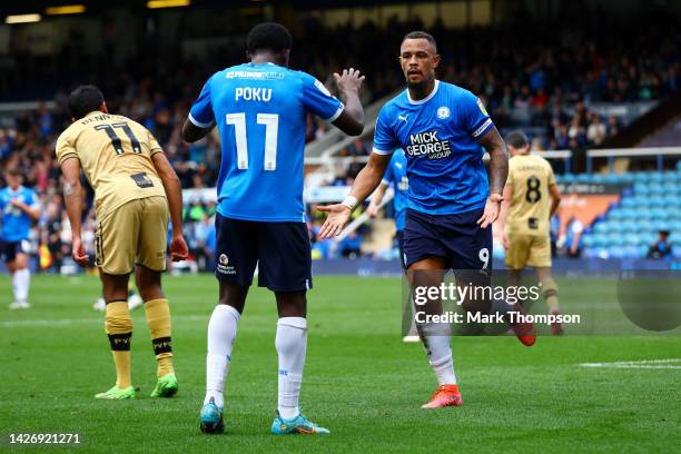 Jonson Clarke-Harris of Peterborough United celebrates scoring their side's second goal with teammate Kwame Poku during the Sky Bet League One...