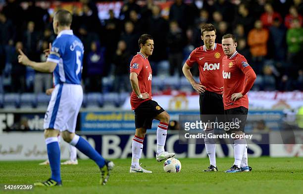 Javier Hernandez, Michael Carrick and Wayne Rooney wait to kick off after Wigan's goal during the Barclays Premier League match between Wigan...