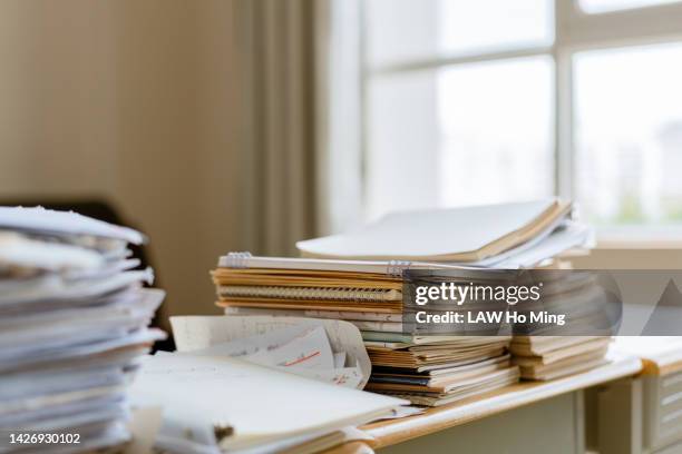 a stack of workbooks on the table - textbook stack stock pictures, royalty-free photos & images