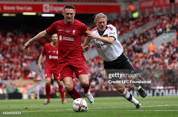 Robbie Keane of Liverpool and Jesper Blomqvist of Manchester United battle for the ball during the Legends of the North match between Liverpool...