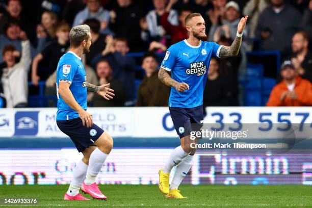 Joe Ward of Peterborough United celebrates scoring their side's third goal with teammate Jack Marriott during the Sky Bet League One between...