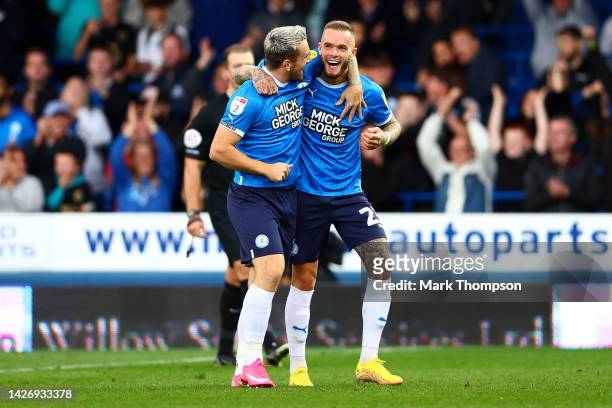 Joe Ward of Peterborough United celebrates scoring their side's third goal with teammate Jack Marriott during the Sky Bet League One between...