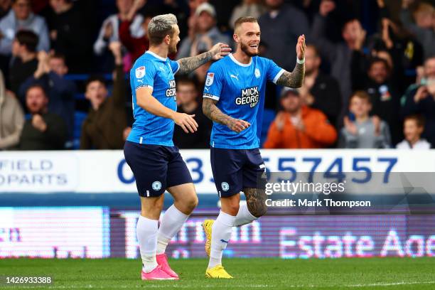 Joe Ward of Peterborough United celebrates scoring their side's third goal with teammate Jack Marriott during the Sky Bet League One between...