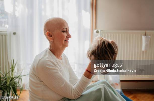 una mujer y una peluca después de la quimioterapia - tupé fotografías e imágenes de stock