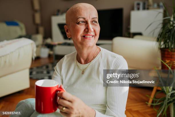 woman who beat cancer enjoys coffee - fight for life imagens e fotografias de stock