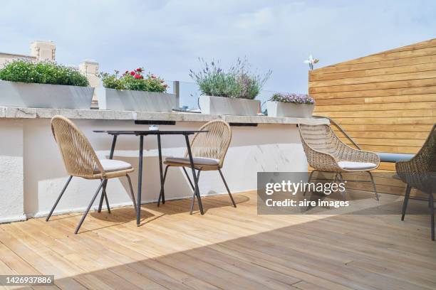 restaurant terrace in the city with beautiful flowers in pots under the clear sky of a sunny summer day. - wicker stock pictures, royalty-free photos & images