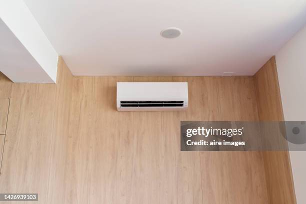 modern office in the city, built-in air conditioning console in wooden wall. - air conditioner interior wall stock pictures, royalty-free photos & images