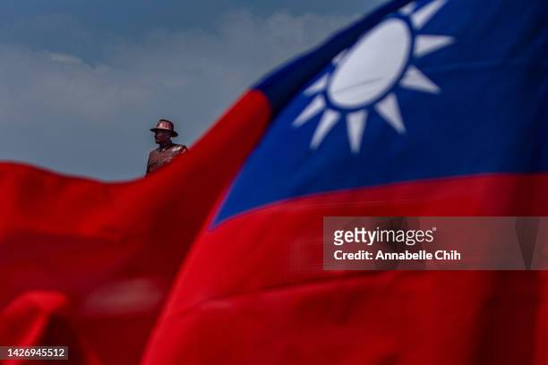 Bronze statue of the former leader of Republic of China, Chiang Kai-shek, is seen behind the national flag of Taiwan on September 24, 2022 in Kinmen,...