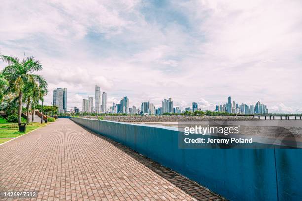 wide angle view of the skyline of panama city, panama from las bóvedas park - panama stock pictures, royalty-free photos & images