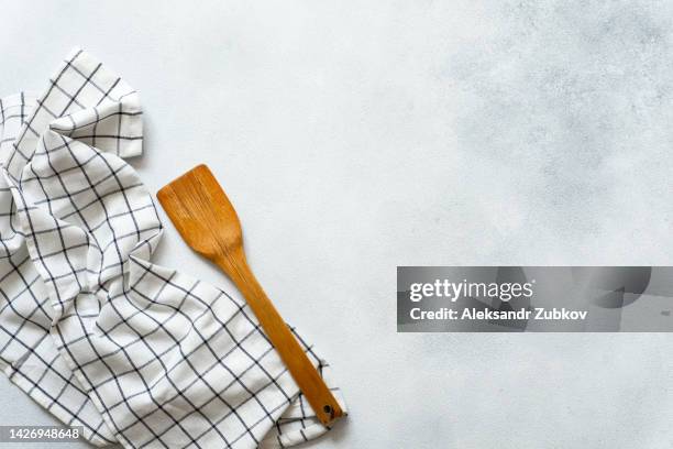 new clean wooden spatula, kitchen towel on the dining table. the concept of cooking in a restaurant and cafe, at home in the kitchen. cook it yourself, courses on the ability to cook delicious and beautiful food. space for copying. - cooking utensil stock pictures, royalty-free photos & images