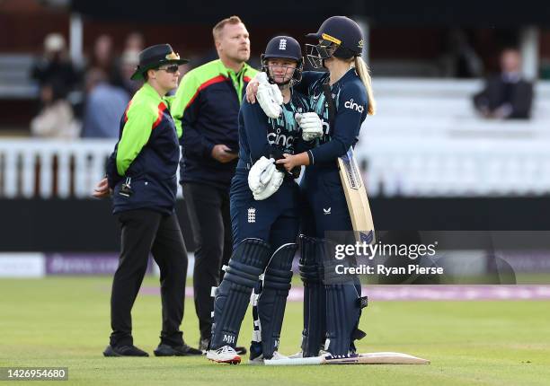 Charlie Dean of England is consoled by Freya Davies of England after Dean was run out Deepti Sharma of India to claim victory during the 3rd Royal...