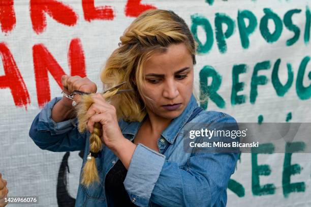 Protester cut the hair as an act of solidarity with women in Iran during a demonstration against the death of 22 year old Mahsa Amini in Iran...