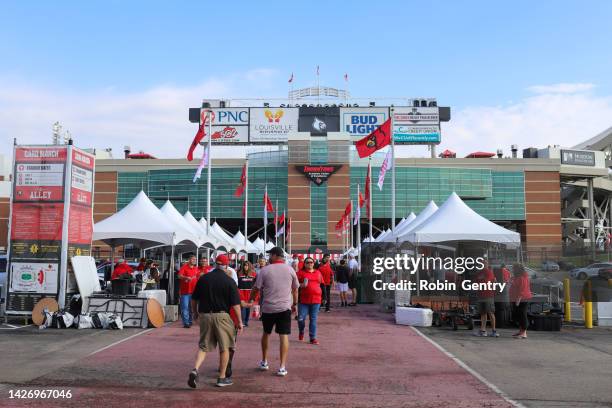 a crowd of people tailgating at a university of louisville football game at cardinal stadium in louisville, kentucky - college football tailgate stock pictures, royalty-free photos & images