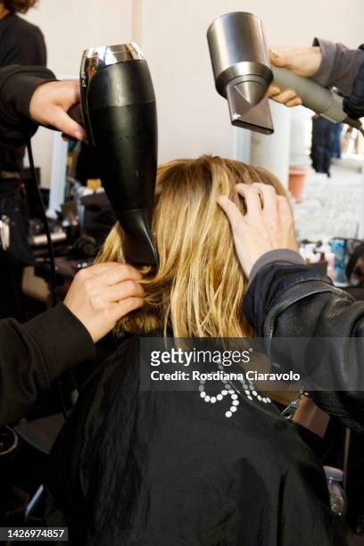Hairstylist prepare a model backstage at the Sportmax Fashion Show during the Milan Fashion Week Womenswear Spring/Summer 2023 on September 23, 2022...