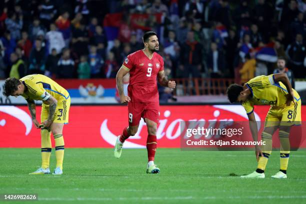 Aleksandar Mitrovic of Serbia celebrates after scoring their team's first goal as Victor Lindeloef and Jens-Lys Cajuste of Sweden react during the...