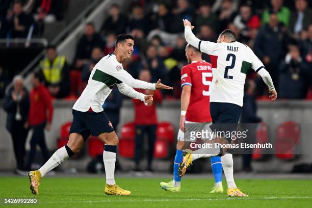 Diogo Dalot of Portugal celebrates scoring their side's third goal with teammate Cristiano Ronaldo during the UEFA Nations League League A Group 2...