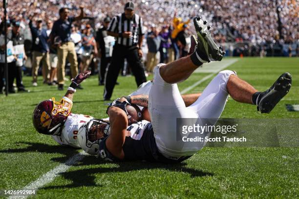 Tight end Brenton Strange of the Penn State Nittany Lions catches a pass for a touchdown against defensive back Jayden Davis of the Central Michigan...