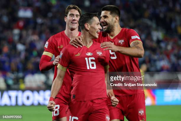 Sasa Lukic of Serbia celebrates with teammates Aleksandar Mitrovic and Dusan Vlahovic after scoring their team's fourth goal during the UEFA Nations...