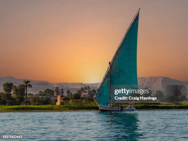 egyptian felucca sailboats on river nile at sunset , luxor, egypt - aswan egypt stock pictures, royalty-free photos & images