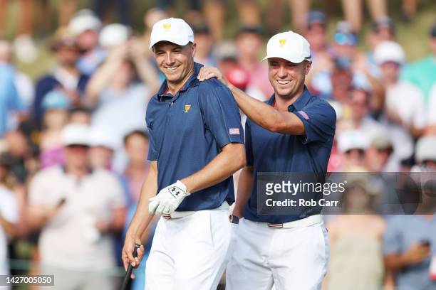 Justin Thomas of the United States Team celebrates with teammate Jordan Spieth after Spieth holed out on the 15th green to win the match 4&3 over...