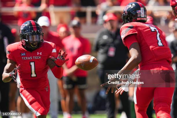 Donovan Smith of the Texas Tech Red Raiders flips the ball to Myles Price of the Texas Tech Red Raiders during the first half against the Texas...