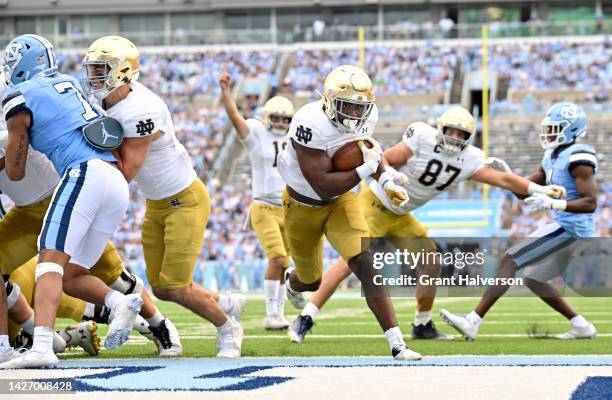 Audric Estime of the Notre Dame Fighting Irish scores a touchdown against the North Carolina Tar Heels during the first half of their game at Kenan...