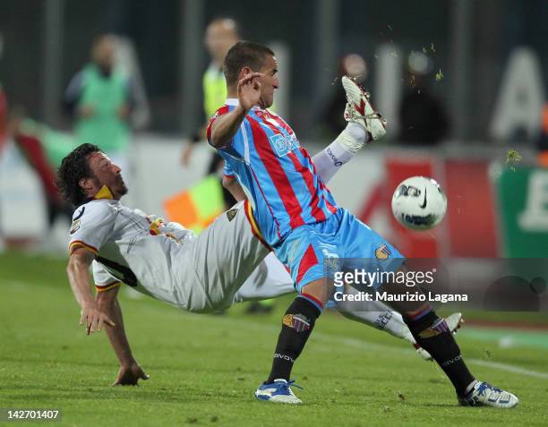 Gonzalo Bergessio of Catania competes for the ball with Massimo Oddo of Lecce during the Serie A match between Catania Calcio and US Lecce at Stadio...