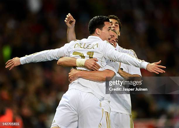 Jose Callejon of Real Madrid celebrates scoring with his teammates Pepe and Alvaro Arbeloa during the La Liga match between Club Atletico de Madrid...