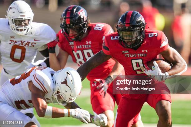 Jerand Bradley of the Texas Tech Red Raiders rushes against defender Jerrin Thompson of the Texas Longhorns during the second half at Jones AT&T...