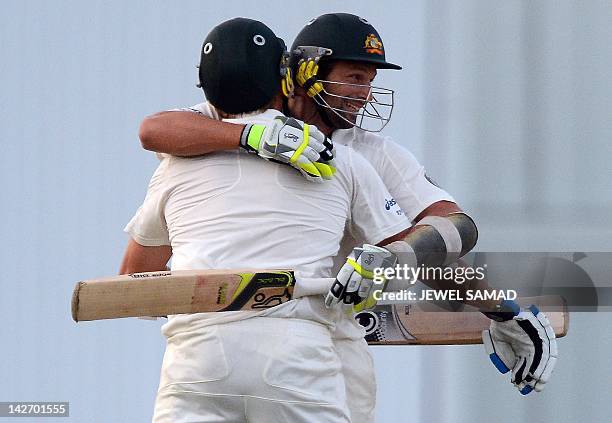 Australian cricketers Ryan Harris and Ben Hilfenhaus celebrate after taking the last run to win during the final day of the first-of-three Test...