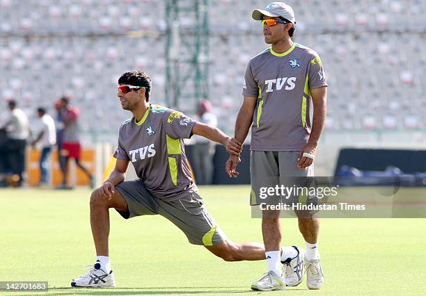 Pune Warriors captain Saurav Ganguly with teammate Ashish Nehra during the practicing session at PCA stadium on April 11, 2012 in Mohali, India. Pune...