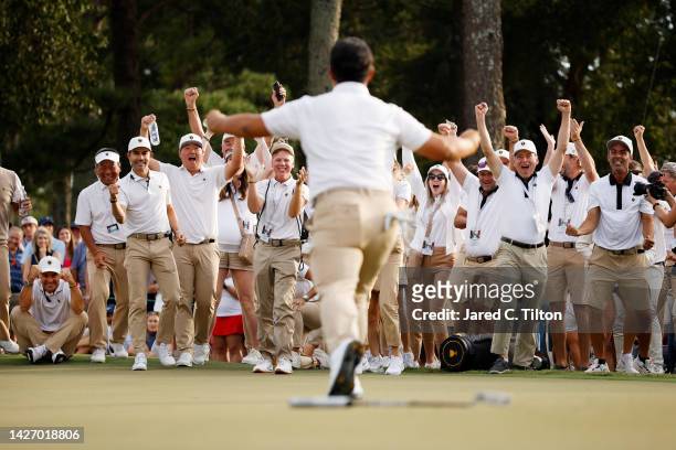 The International Team cheers as Tom Kim of South Korea and the International Team celebrates his hole-winning putt to win the match 1 Up with...