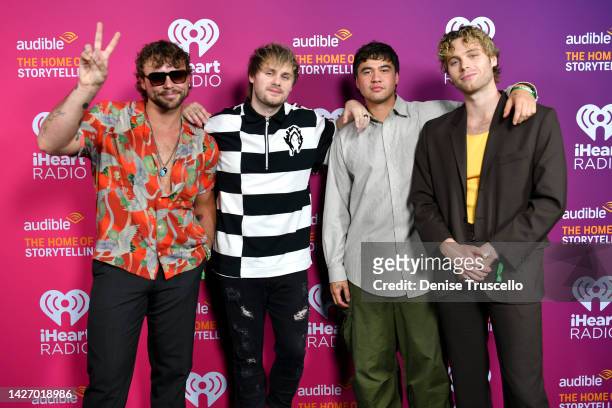 Ashton Irwin, Michael Clifford, Calum Hood and Luke Hemmings of 5 Seconds of Summer are seen backstage during the Daytime Stage at the 2022...