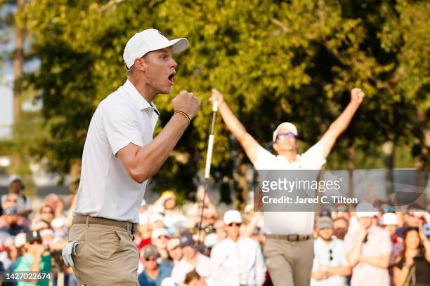 Cam Davis of Australia and the International Team celebrates his hole-winning putt on the 17th green to win 1 Up with teammate Adam Scott of...