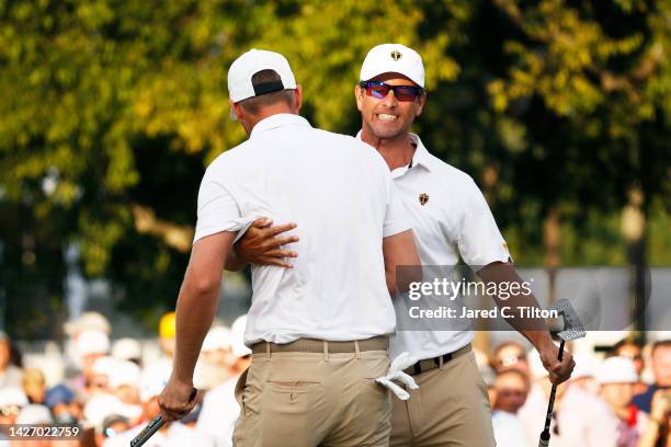 Adam Scott of Australia and Cam Davis of Australia and the International Team celebrate on the 17th green during Saturday afternoon four-ball matches...