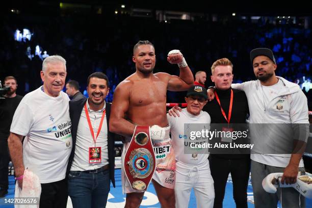 Joe Joyce celebrates with their team and the Vacant WBO Interim World Heavyweight Championship belt after defeating Joseph Parker in the Vacant WBO...