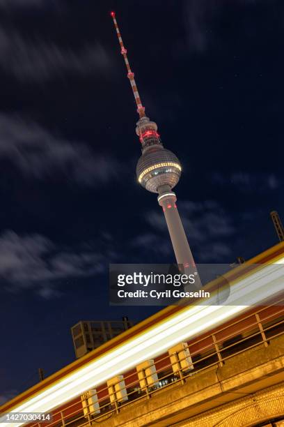 berlin television tower and s-bahn train at night. berlin, germany. - berlin nacht stock pictures, royalty-free photos & images