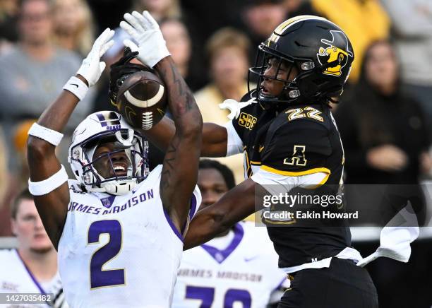 Chauncey Logan of the James Madison Dukes blocks a catch by Dalton Stroman of the Appalachian State Mountaineers in the fourth quarter at Kidd Brewer...