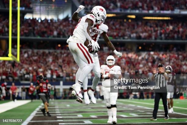 Wide receiver of the Arkansas Razorbacks celebrates with wide receiver Warren Thompson of the Arkansas Razorbacks after scoring a touchdown against...