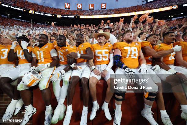 The Tennessee Volunteers team celebrates in the stands with the fans after a win against the Florida Gators at Neyland Stadium on September 24, 2022...