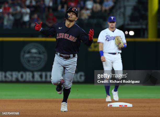 Andres Gimenez of the Cleveland Guardians gestures as he runs the bases after a solo home run against the Texas Rangers in the seventh inning at...