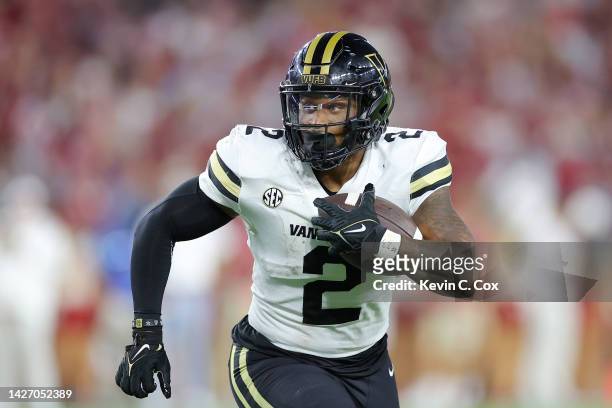 Ray Davis of the Vanderbilt Commodores runs the ball against the Alabama Crimson Tide during the first half of the game at Bryant-Denny Stadium on...