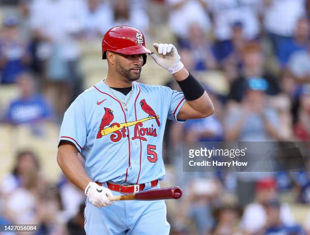 Albert Pujols of the St. Louis Cardinals gestures to the applause of the crowd as he steps into the batters box during the first inning against the...