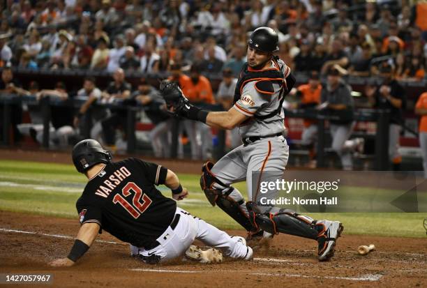 Daulton Varsho of the Arizona Diamondbacks slides safely into home ahead of the tag by Joey Bart of the San Francisco Giants during the fourth inning...